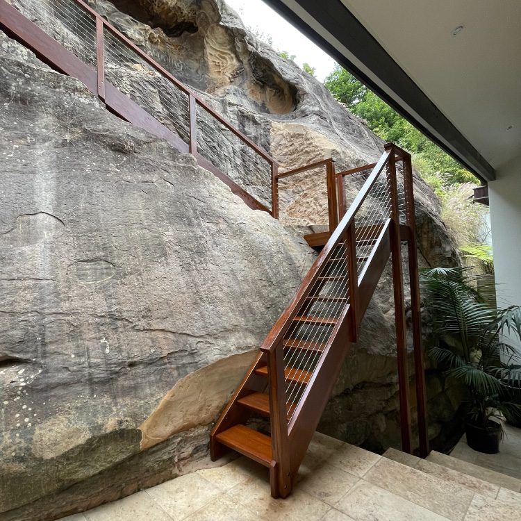 Wooden outdoor staircase built into sandstone